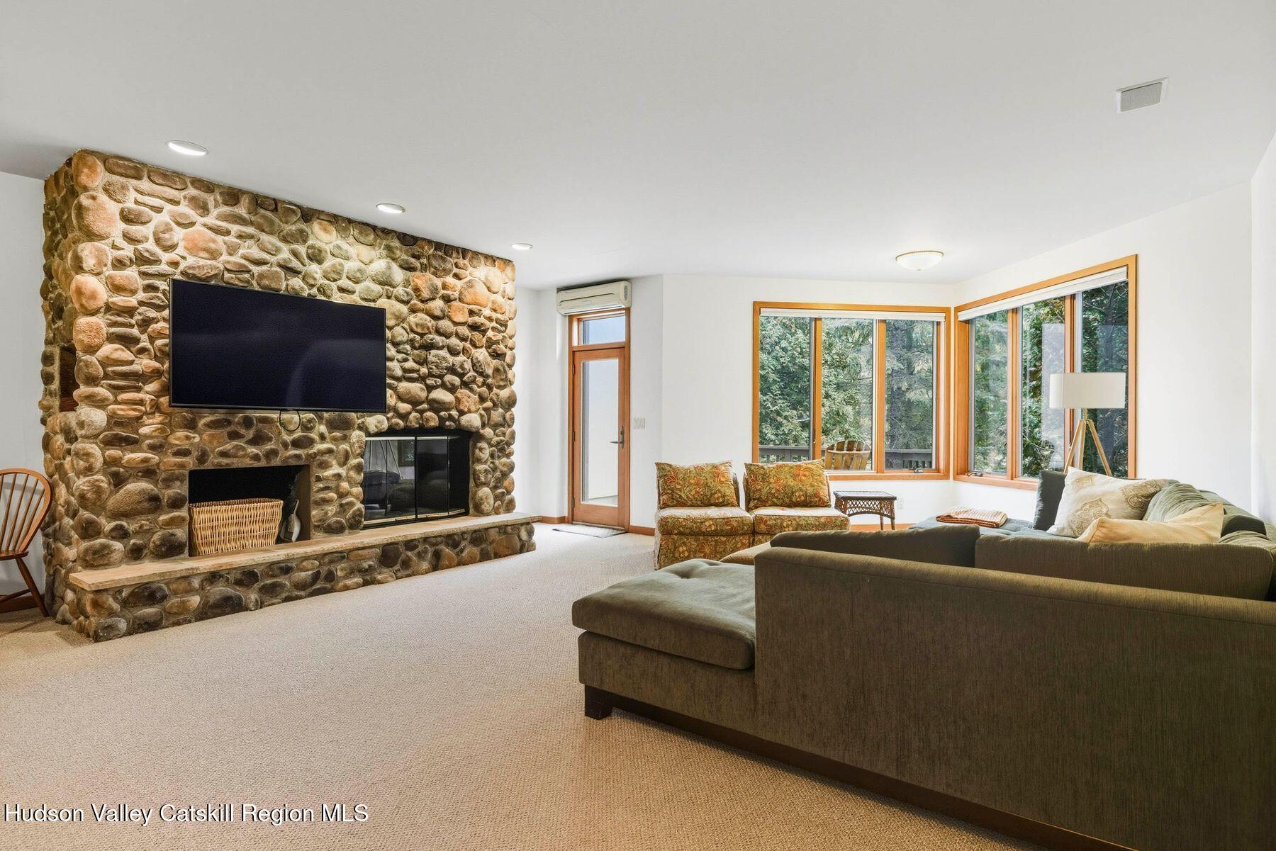 3 The Enclave Windham, NY 12496 - Photo 3 of 59 a living room with fireplace furniture and a flat screen tv