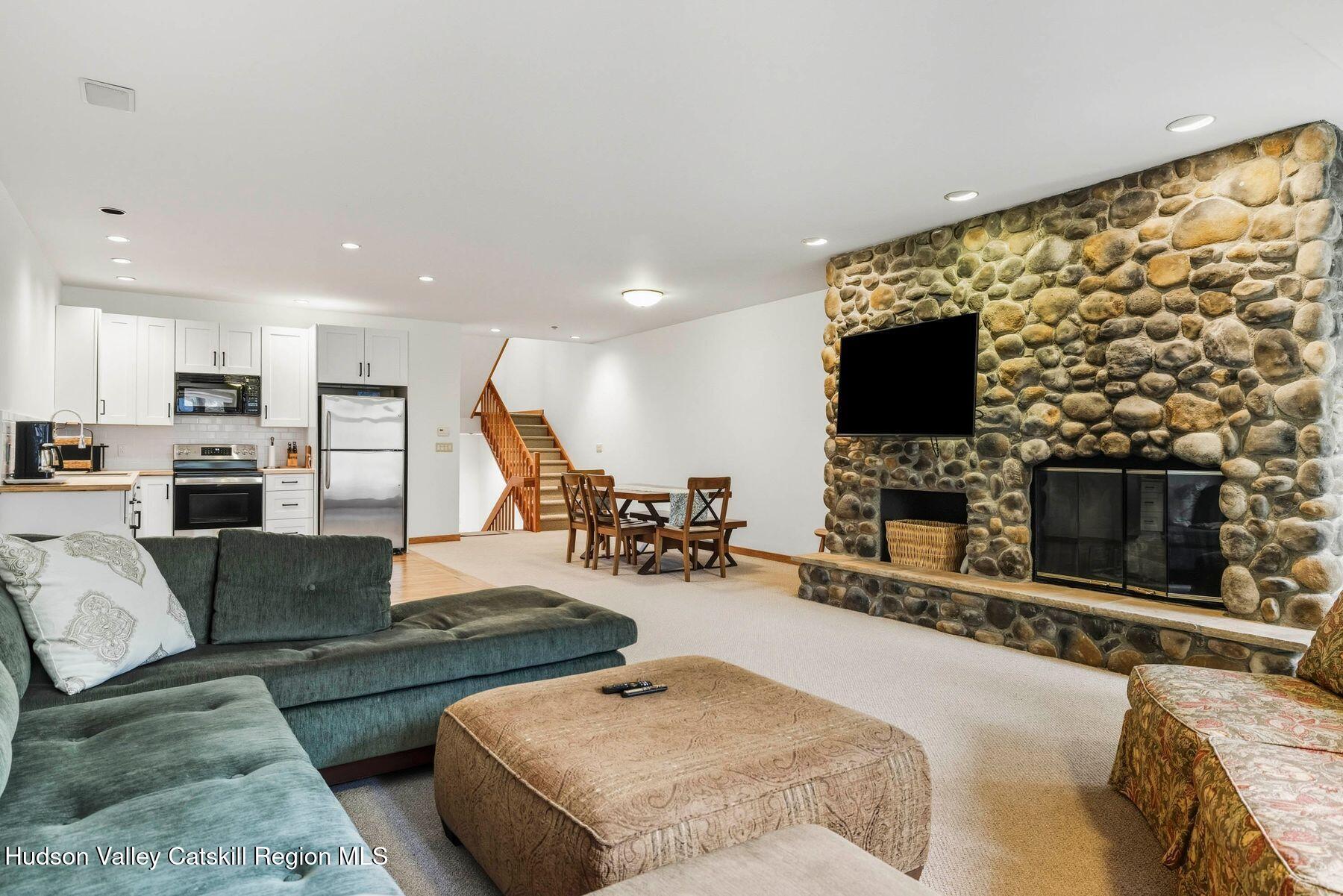 3 The Enclave Windham, NY 12496 - Photo 4 of 59 a living room with fireplace furniture and a flat screen tv