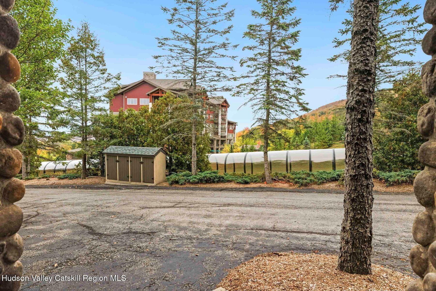 3 The Enclave Windham, NY 12496 - Photo 45 of 59 a front view of a house with a yard and trees
