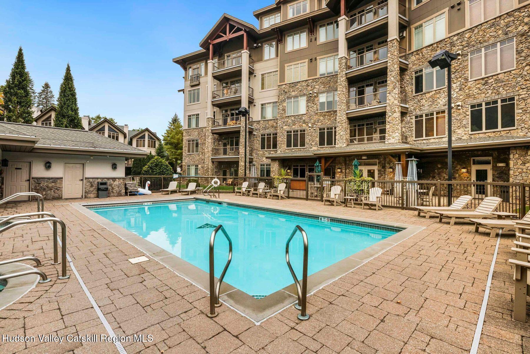 3 The Enclave Windham, NY 12496 - Photo 47 of 59 a view of a swimming pool with a lounge chairs