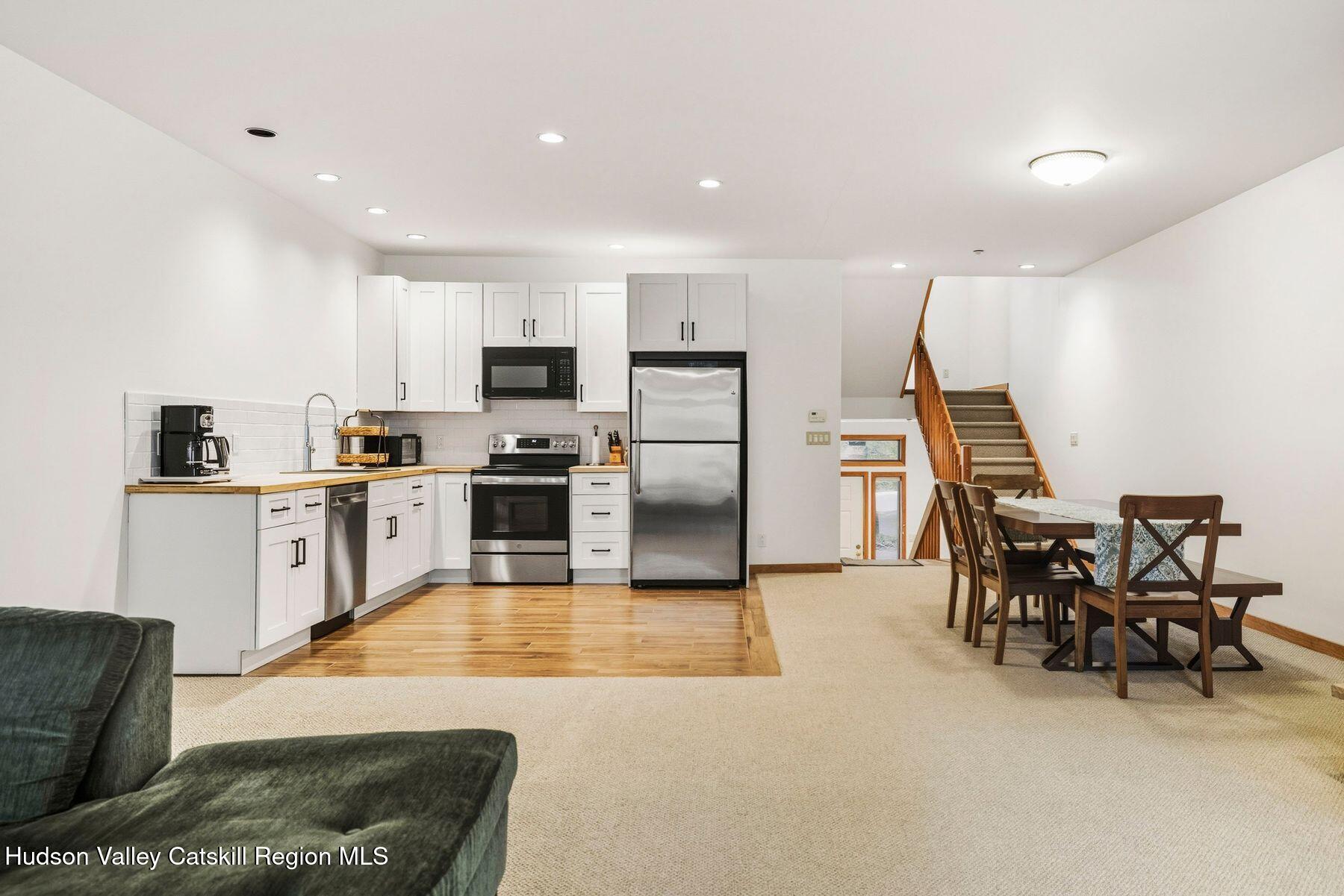 3 The Enclave Windham, NY 12496 - Photo 9 of 59 a kitchen with stainless steel appliances kitchen island granite countertop a refrigerator and cabinets