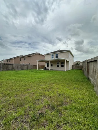a view of house with backyard