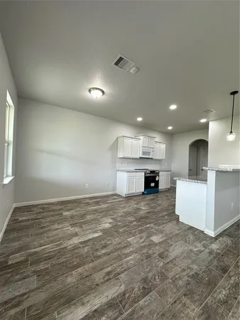 a view of kitchen and a sink with wooden floor
