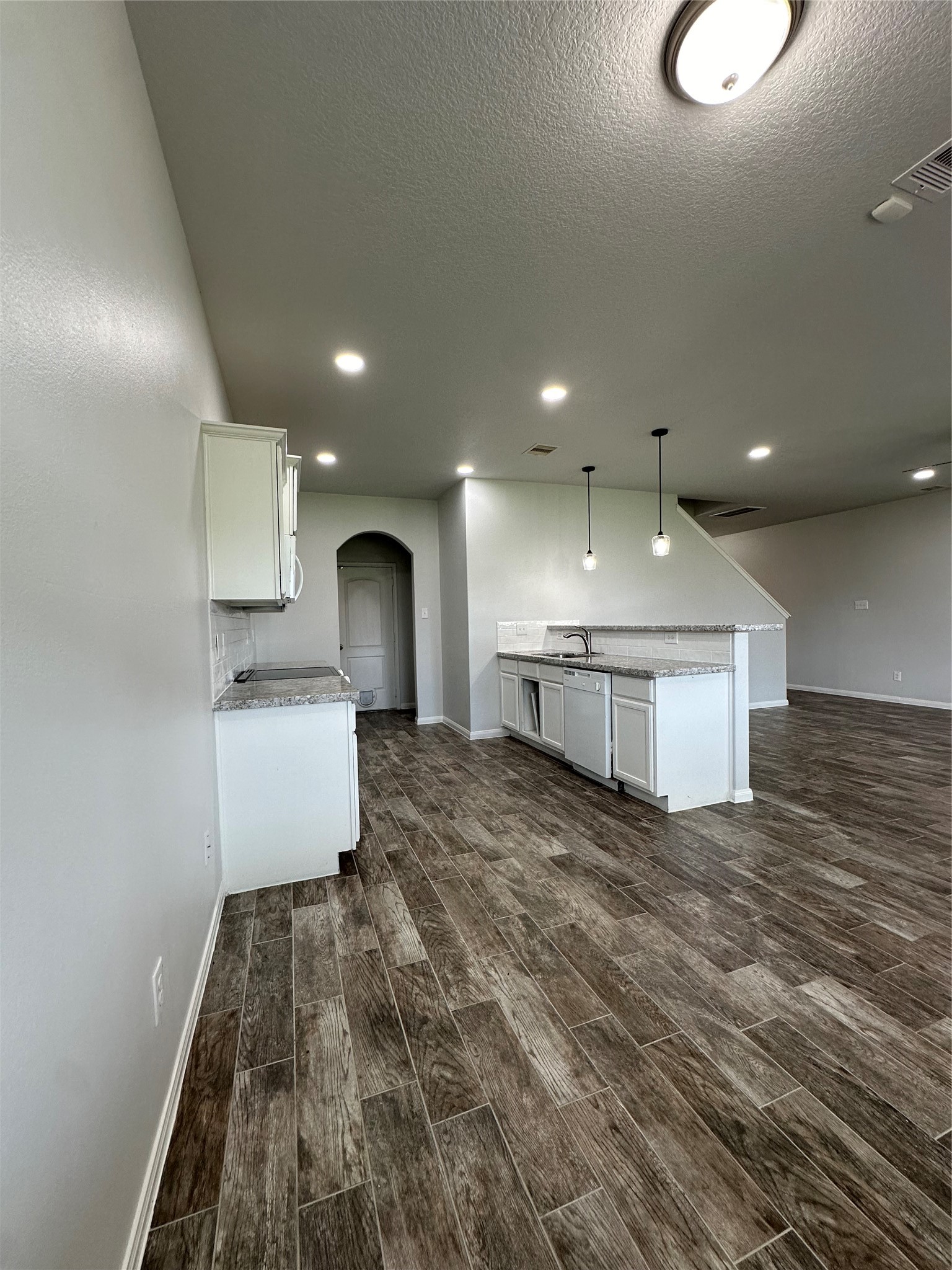 5819 Golden Cove Road Cove, TX 77523 - Photo 7 of 19 a kitchen with kitchen island a sink stainless steel appliances and cabinets