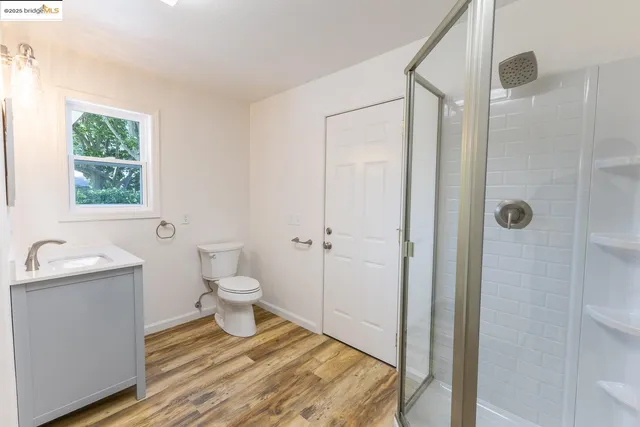 a bathroom with a toilet a sink and shower