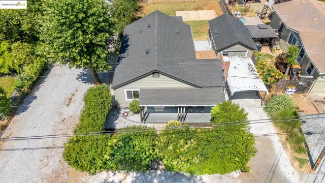 an aerial view of a house with garden space and street view