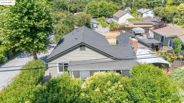 an aerial view of a house with a yard and outdoor seating