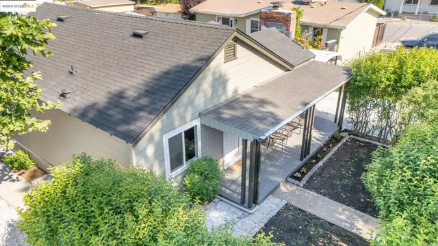 an aerial view of house with yard and trees in the background