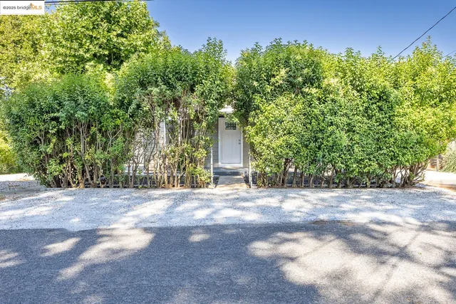 a view of a house with a yard and garage