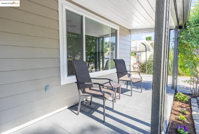 a view of a patio with a dining table and chairs