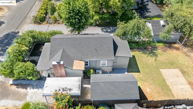 an aerial view of a house with outdoor space