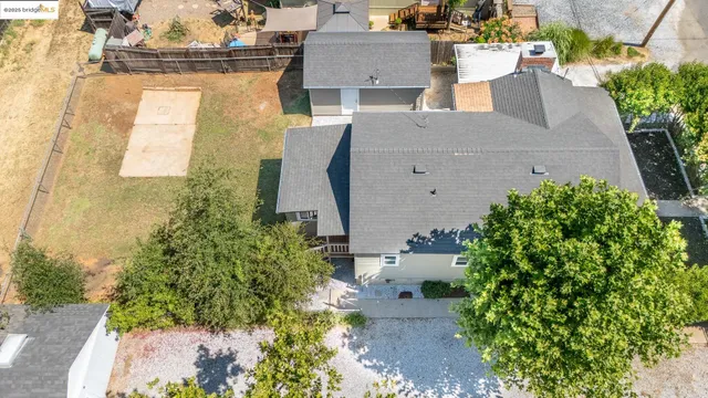 an aerial view of a house with a yard and garden