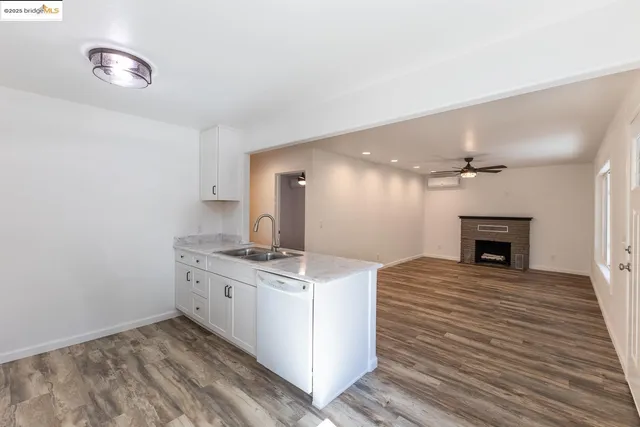 a view of a kitchen with a sink and a fireplace