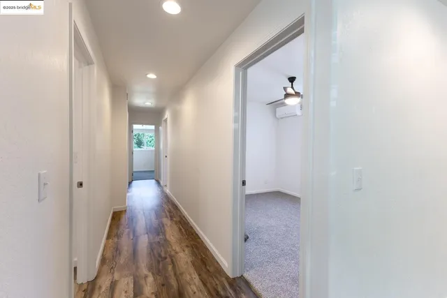 a view of hallway with wooden floor