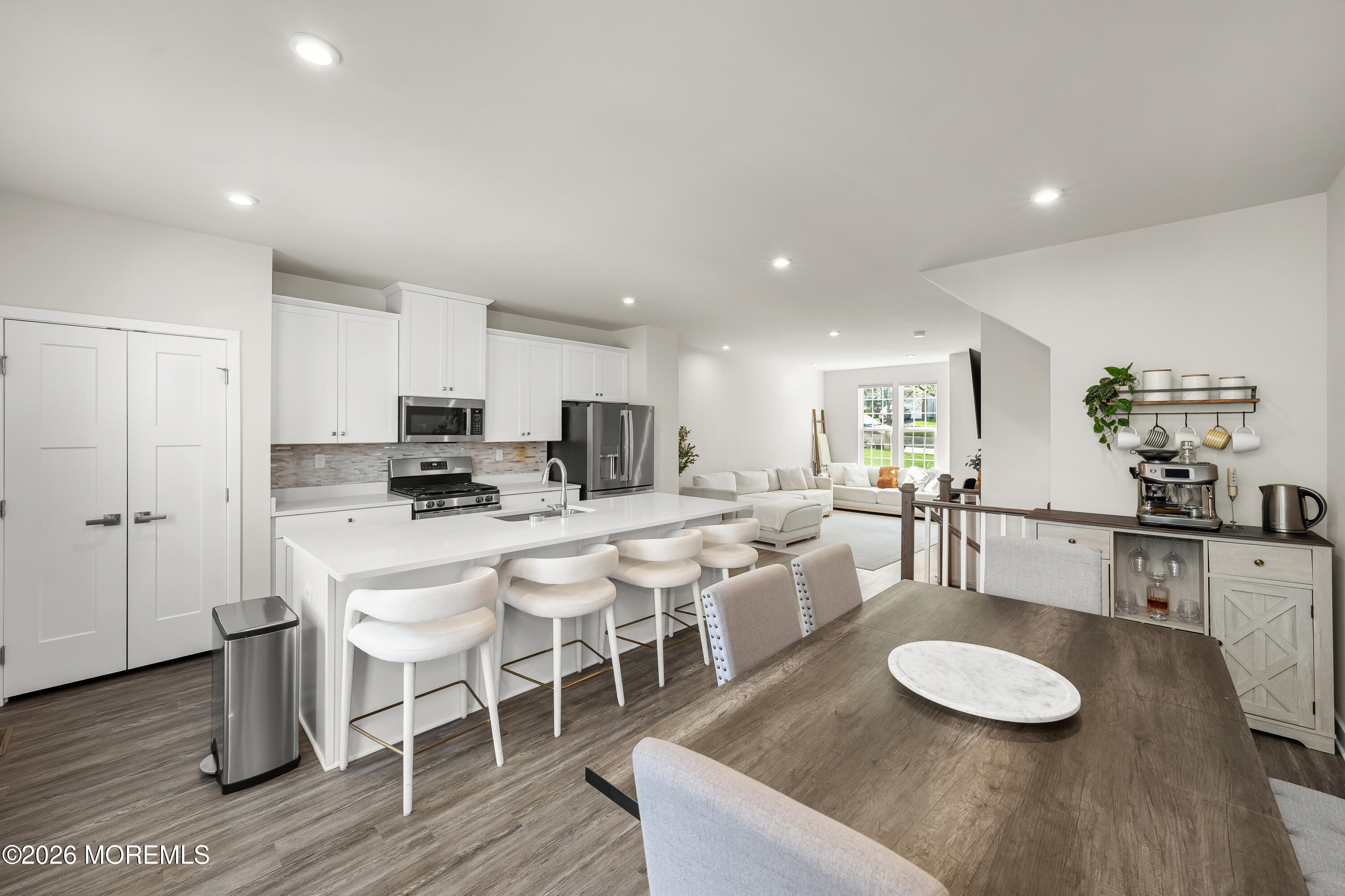 1306 English Lane, Unit 1306 Parlin, NJ 08859 - Photo 17 of 41 a kitchen with stainless steel appliances granite countertop a dining table chairs and white cabinets