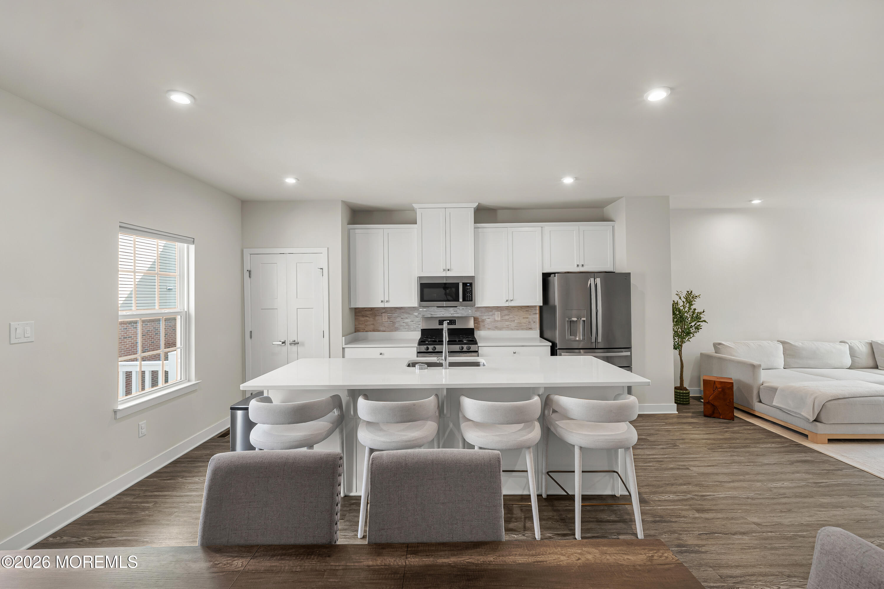 1306 English Lane, Unit 1306 Parlin, NJ 08859 - Photo 20 of 41 a living room with furniture a dining table and kitchen view