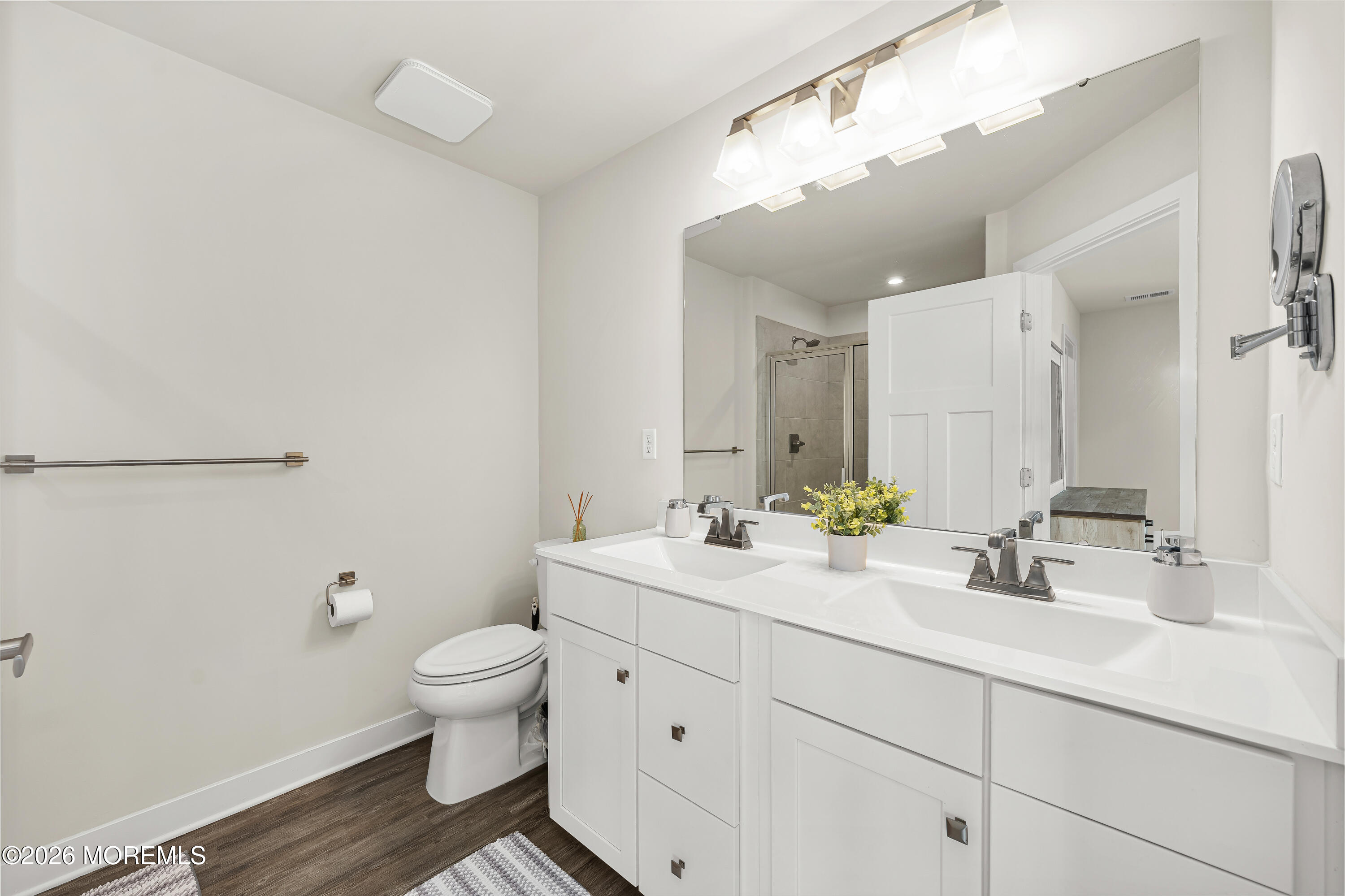 1306 English Lane, Unit 1306 Parlin, NJ 08859 - Photo 34 of 41 a bathroom with a double vanity sink toilet and a mirror