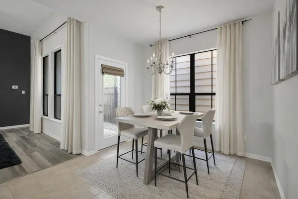 a view of a dining room with furniture and window