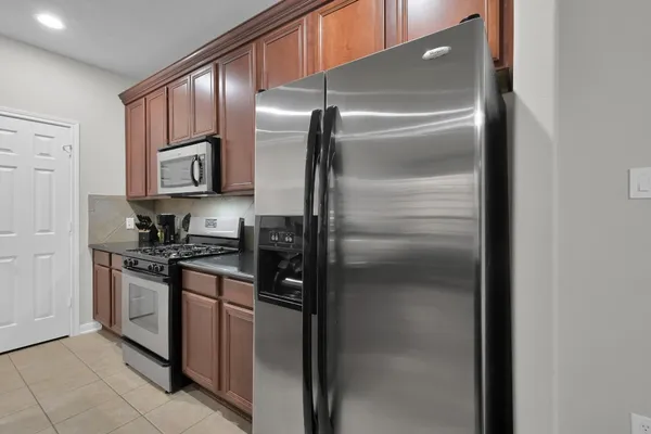 a kitchen with a refrigerator and cabinets