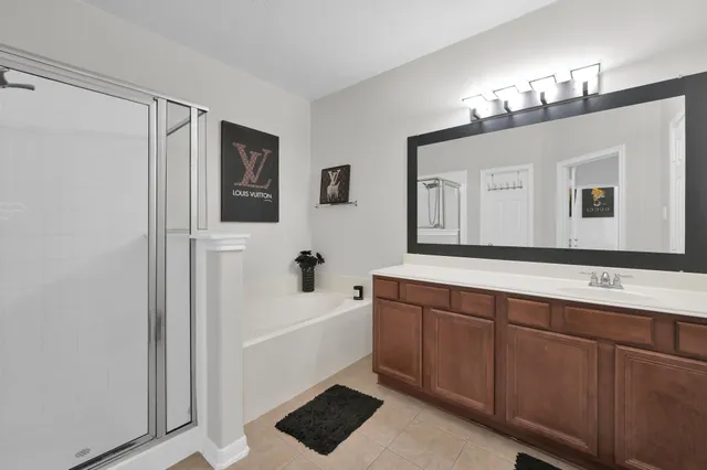 a bathroom with a sink a large mirror and a bathtub