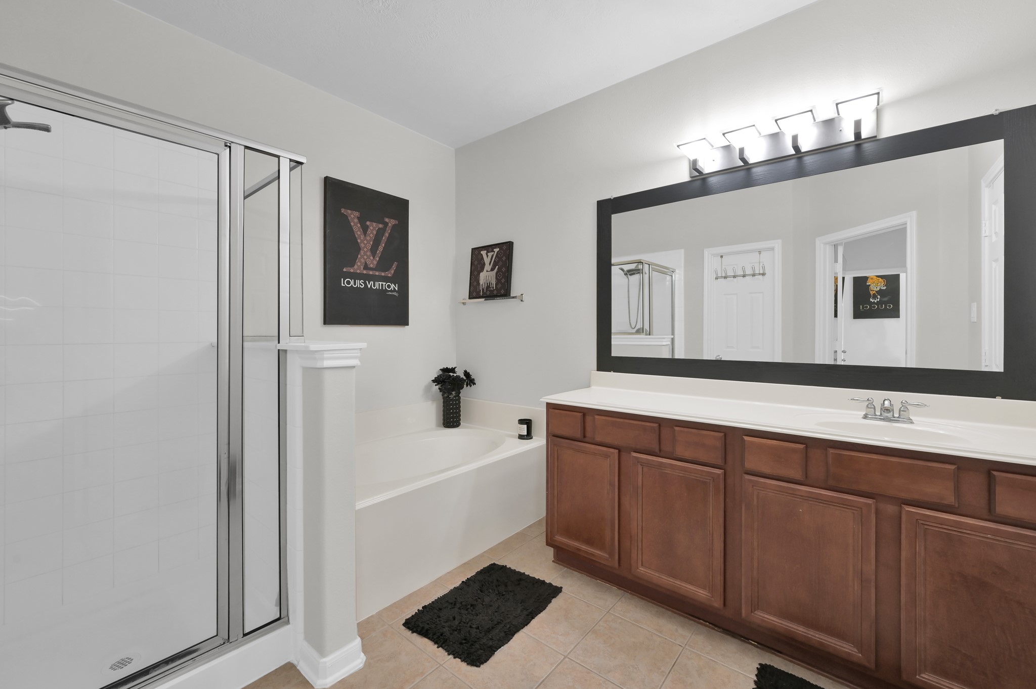 3607 Cedar Flats Lane Spring, TX 77386 - Photo 16 of 47 a bathroom with a sink a large mirror and a bathtub