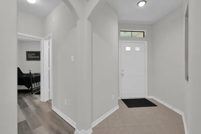 a walk in closet with view of bedroom