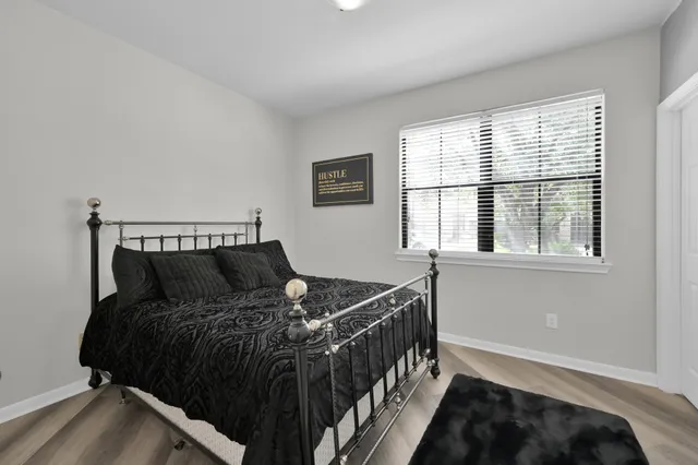 a bed sitting in a bedroom next to a window