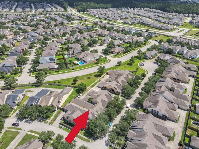 an aerial view of residential houses with outdoor space