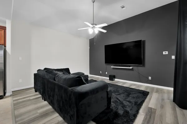 a bedroom with a large bed and a chandelier