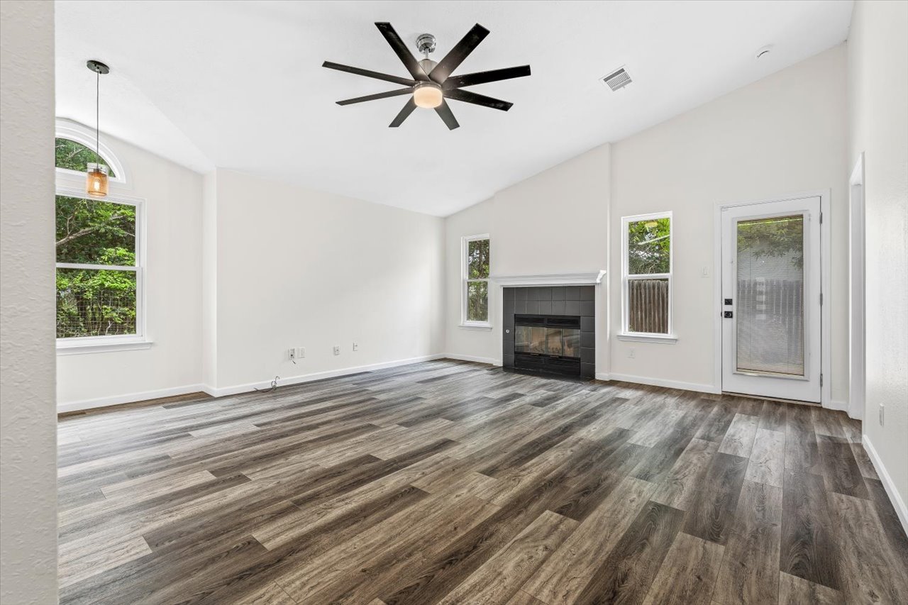 4004 Danli Lane Austin, TX 78749 - Photo 17 of 40 an empty room with windows and a fireplace