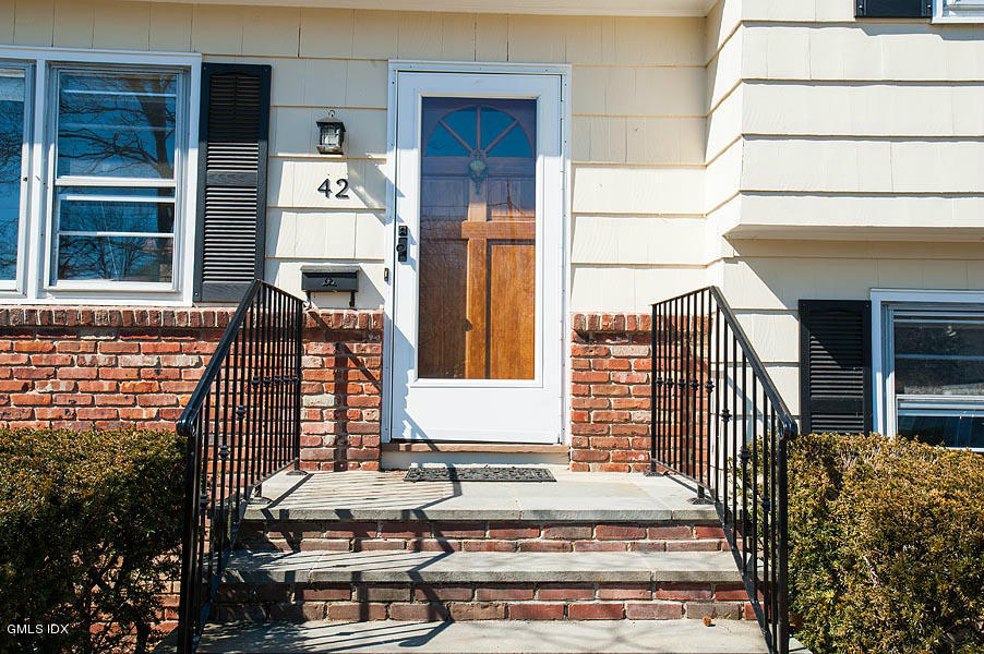 42 Field Road Cos Cob, CT 06807 - Photo 2 of 14 a front view of a house with a balcony