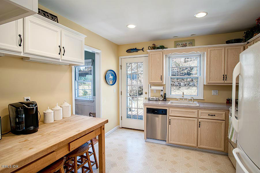 42 Field Road Cos Cob, CT 06807 - Photo 7 of 14 a kitchen with stainless steel appliances granite countertop a sink and cabinets