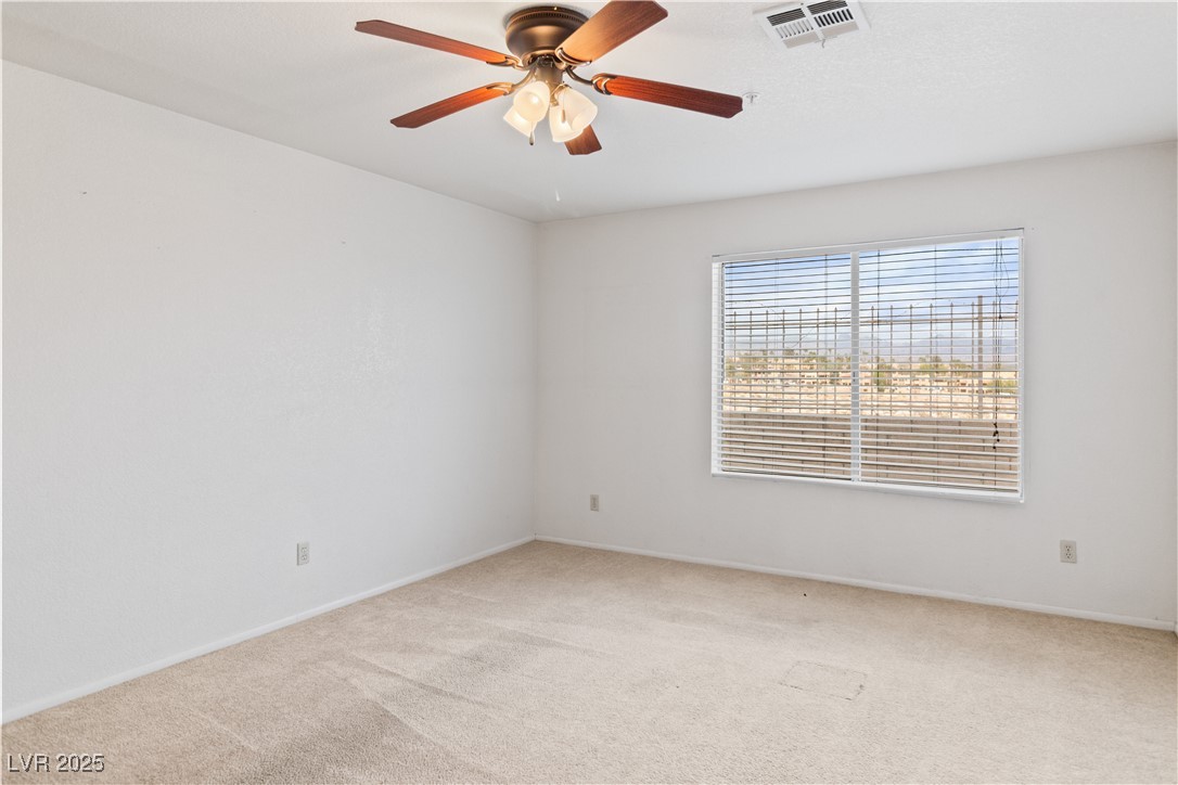 2036 Mesquite Lane, Unit 103 Laughlin, NV 89029 - Photo 14 of 67 Empty room with baseboards, visible vents, ceiling fan, and carpet floors