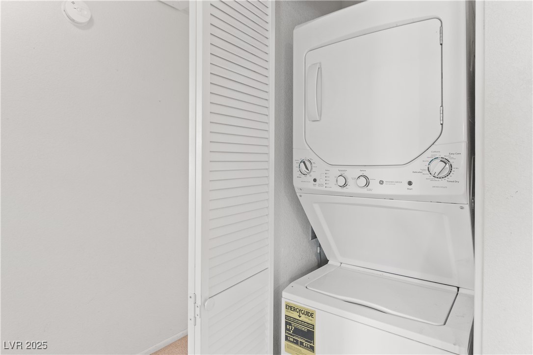 2036 Mesquite Lane, Unit 103 Laughlin, NV 89029 - Photo 19 of 67 Washroom featuring baseboards, stacked washer / dryer, and laundry area