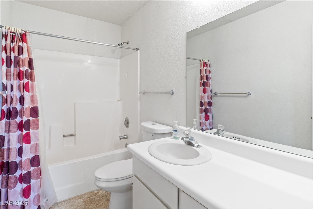 2036 Mesquite Lane, Unit 103 Laughlin, NV 89029 - Photo 23 of 67 Bathroom featuring toilet, vanity, and shower / bath combo with shower curtain