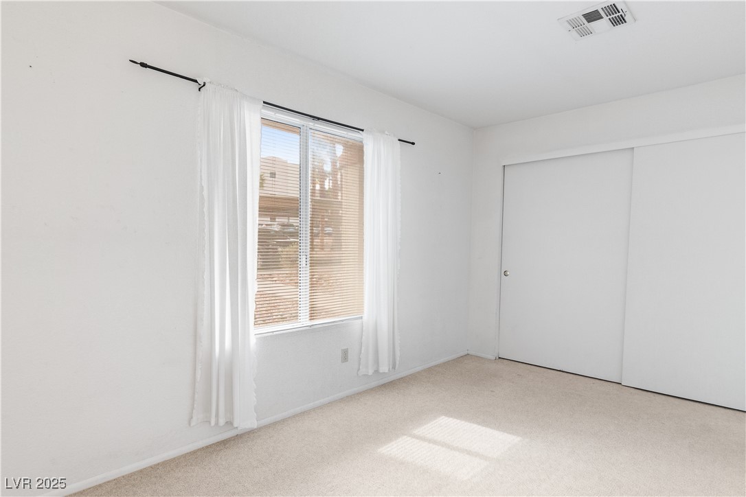 2036 Mesquite Lane, Unit 103 Laughlin, NV 89029 - Photo 26 of 67 Unfurnished bedroom with visible vents, a closet, and carpet flooring