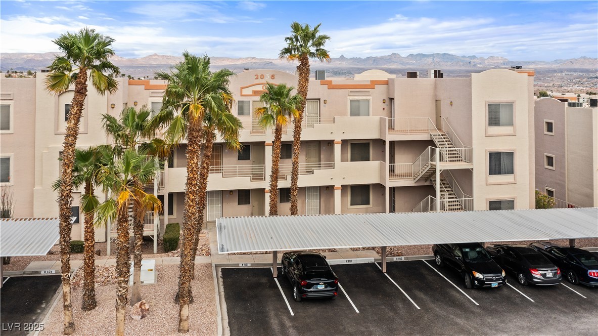 2036 Mesquite Lane, Unit 103 Laughlin, NV 89029 - Photo 39 of 67 View of building exterior with covered parking and a mountain view