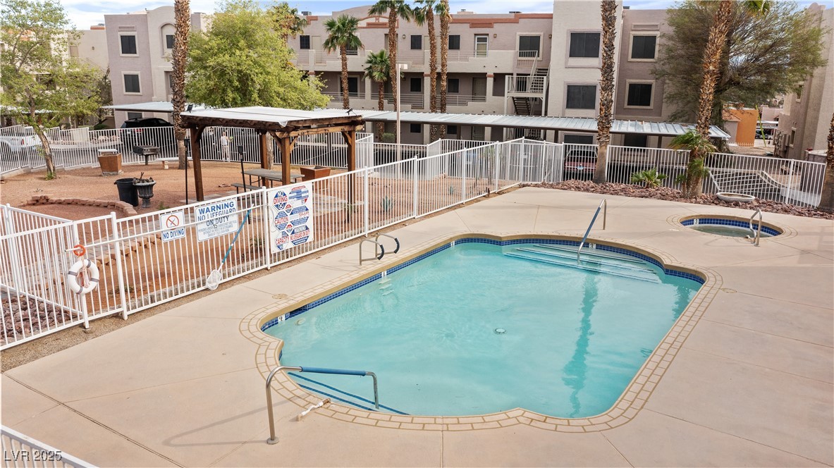 2036 Mesquite Lane, Unit 103 Laughlin, NV 89029 - Photo 48 of 67 View of swimming pool with a residential view, fence, a hot tub, and a patio