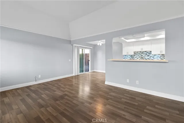 a view of wooden floor and windows in a room