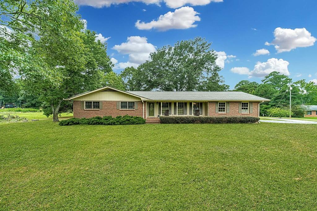 165 Russell Braden Road Covington, GA 30016 - Photo 1 of 1 a front view of a house with garden