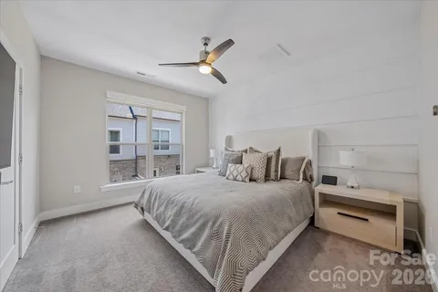a bedroom with a bed and painting on the wall