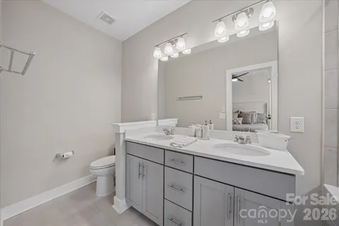 a bathroom with a shower sink double and mirror