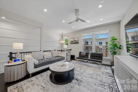 a living room with furniture a rug and a chandelier