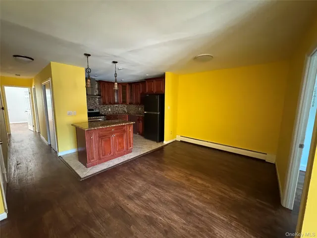 a view of a kitchen with a sink and wooden floor