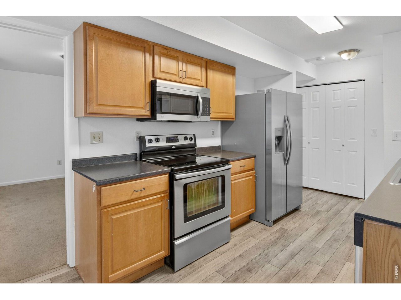 2317 Walnut Street Boulder, CO 80302 - Photo 10 of 34 a kitchen with stainless steel appliances a stove a microwave a sink and cabinets