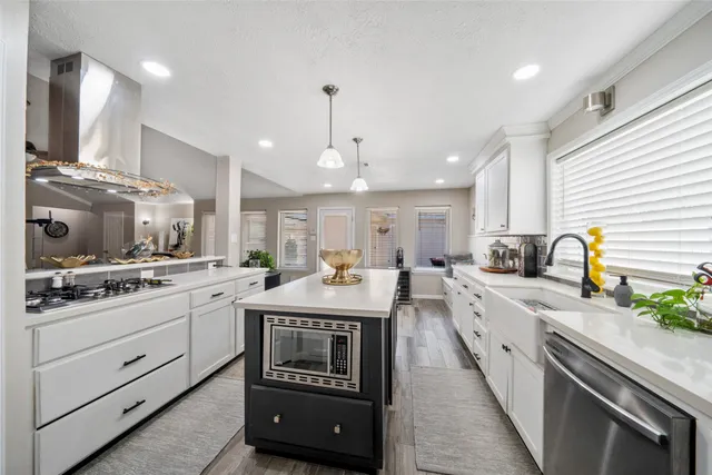 a kitchen with stainless steel appliances granite countertop a sink and cabinets