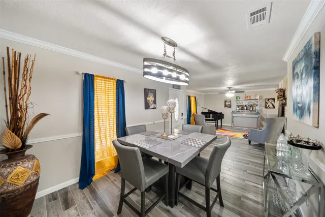 a view of a dining room with furniture and a chandelier