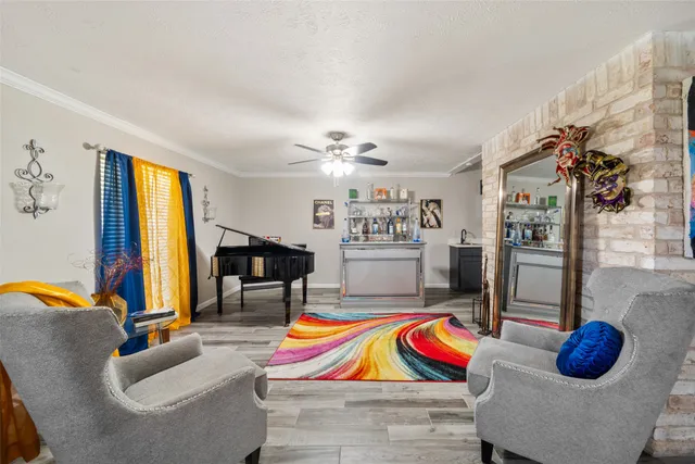 a living room with furniture and a floor to ceiling window