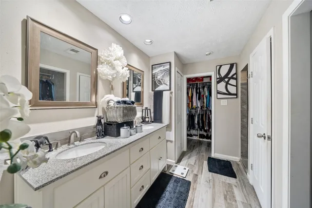 a bathroom with double vanity sink and a mirror