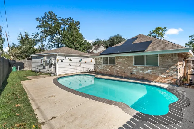 a view of a swimming pool with an outdoor space and seating area